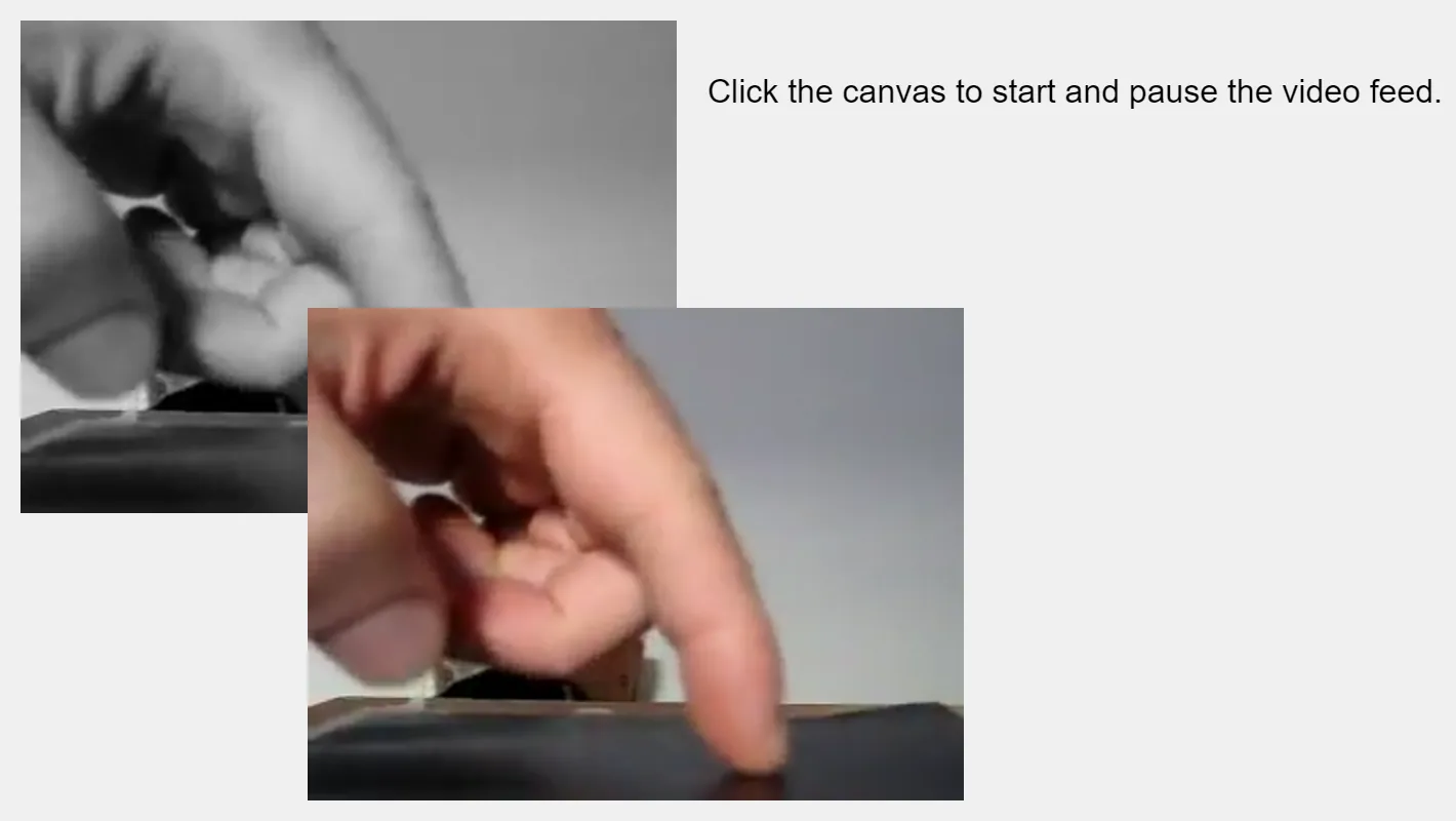 Two overlaid screenshots of a video of a hand, with the pointer finger touching a desk. Text to the top right of the screenshot reads "Click the canvas to start and pause the video feed."