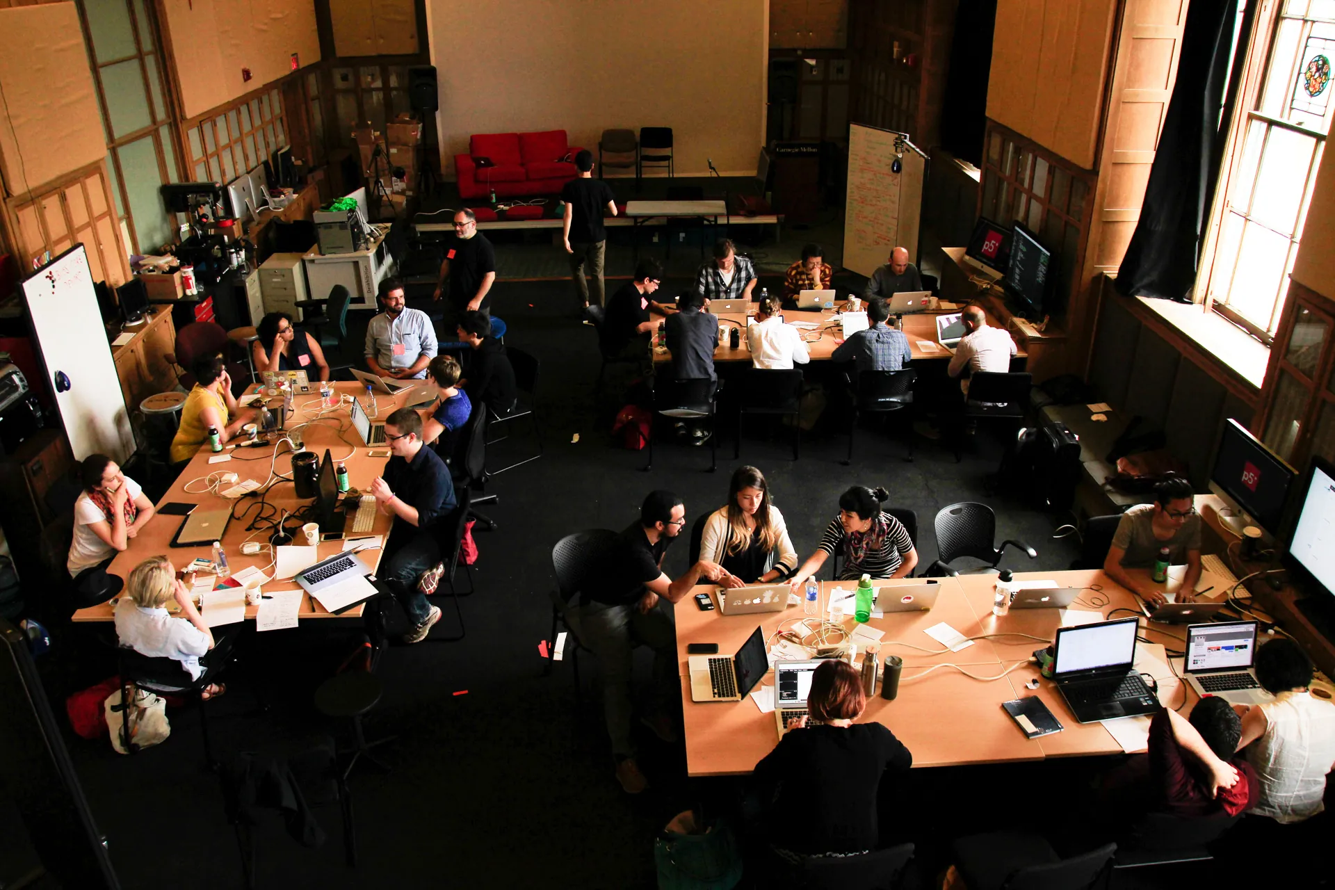 Overhead view of a classroom with participants working on their laptops