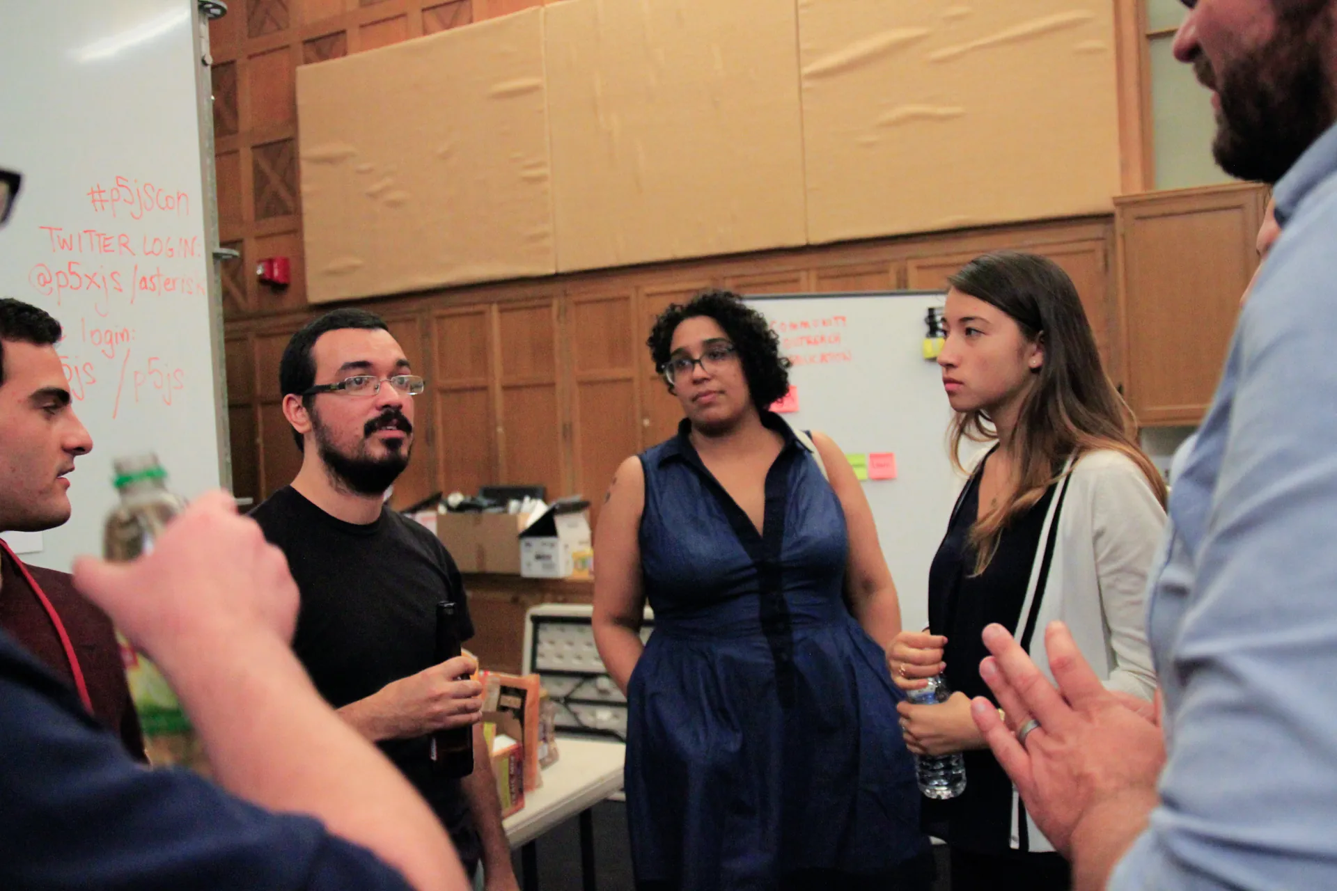 Five people having a discussion in a circle