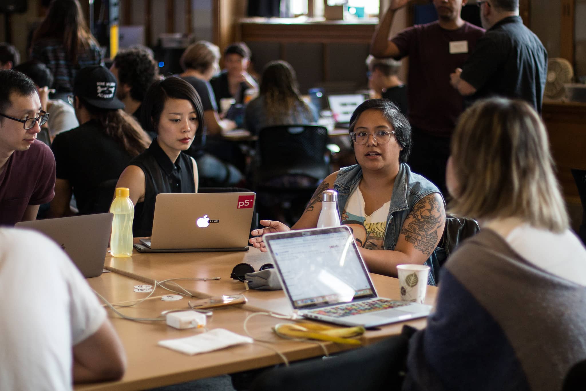 Participants conversing in a busy classroom