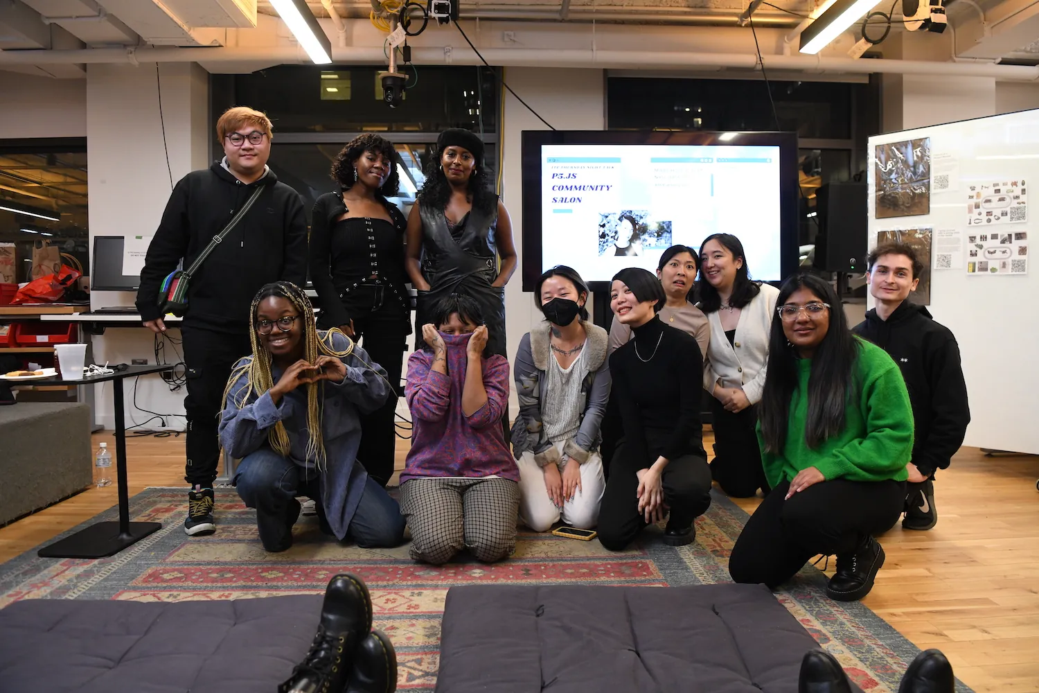 A group image of all the presenters and organizers, smiling and making silly faces at the camera. They are mostly kneeling down and few are standing upright.